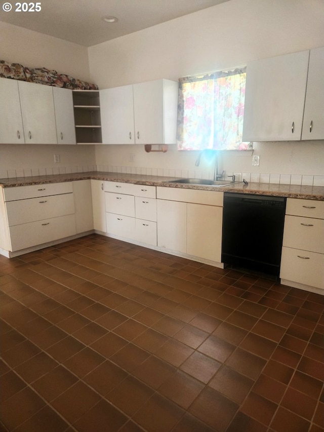 kitchen with open shelves, black dishwasher, white cabinetry, dark tile patterned flooring, and a sink