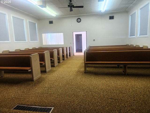 miscellaneous room featuring visible vents, carpet, and ceiling fan