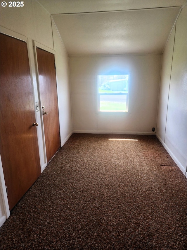 carpeted spare room with baseboards