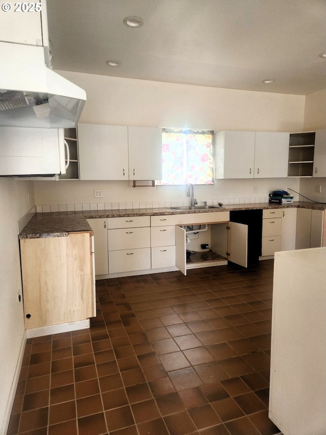 kitchen featuring white cabinets, open shelves, and a sink