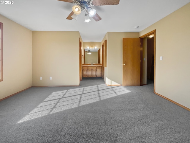 unfurnished bedroom with carpet floors, connected bathroom, baseboards, and a ceiling fan