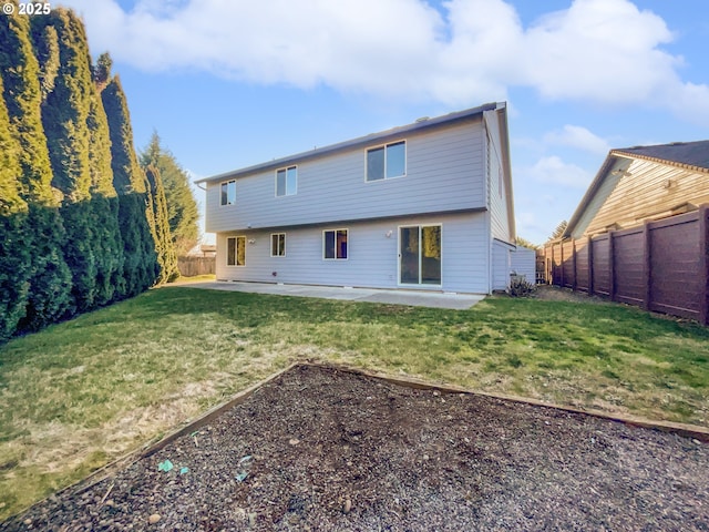 back of property with a patio, a lawn, and a fenced backyard