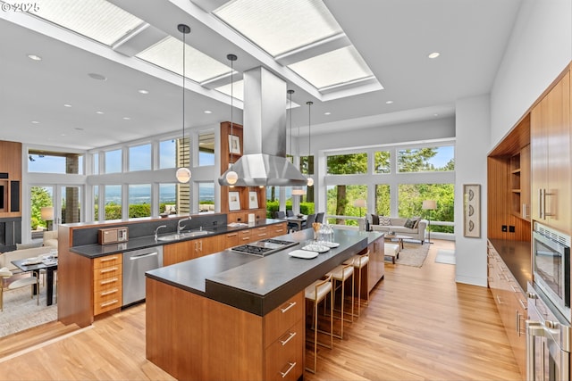 4140 NW Thunder Crest Rd, Portland, OR 97229 - kitchen featuring open floor plan, appliances with stainless steel finishes, modern cabinets, dark countertops, and a towering ceiling