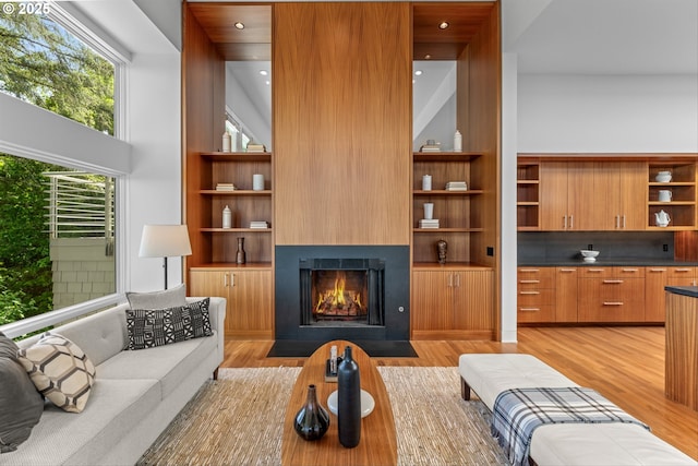 4140 NW Thunder Crest Rd, Portland, OR 97229 - living room with light wood finished floors, a large fireplace, recessed lighting, and built in shelves