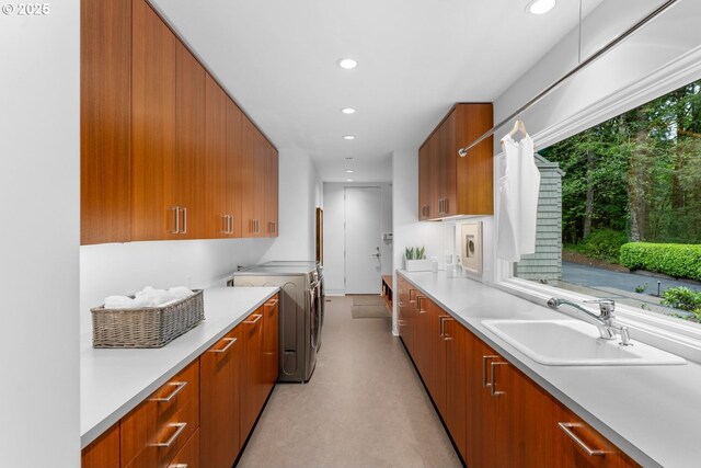 4140 NW Thunder Crest Rd, Portland, OR 97229 - kitchen featuring washer and dryer, a sink, modern cabinets, brown cabinetry, and light countertops