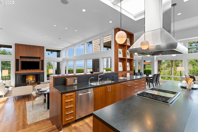 4140 NW Thunder Crest Rd, Portland, OR 97229 - kitchen with a sink, stainless steel appliances, island exhaust hood, open floor plan, and a towering ceiling