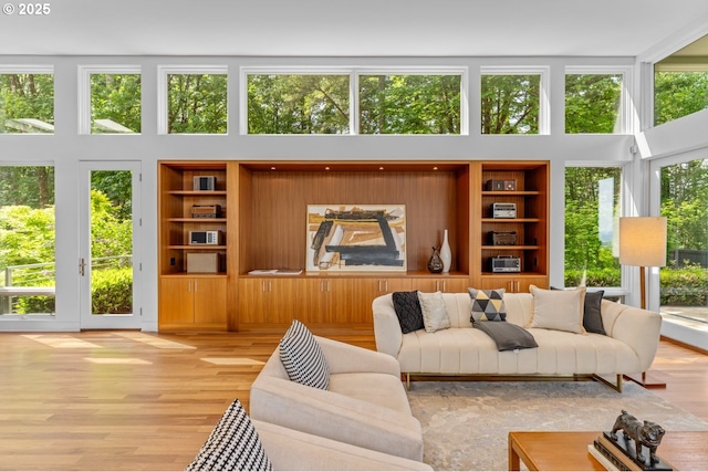 4140 NW Thunder Crest Rd, Portland, OR 97229 - living area with a towering ceiling, wood finished floors, and built in shelves