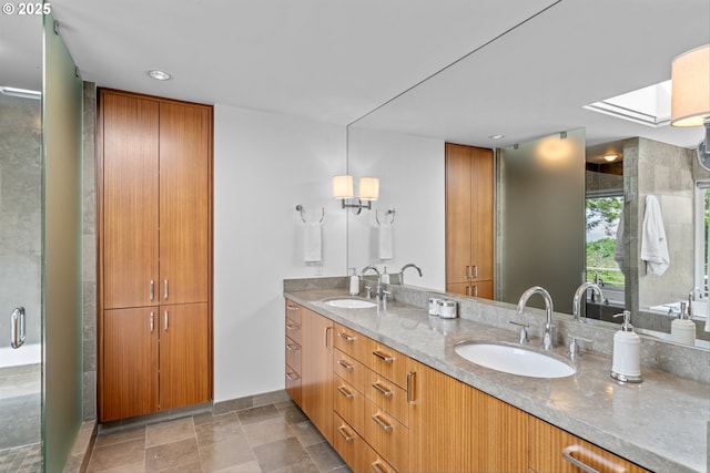 4140 NW Thunder Crest Rd, Portland, OR 97229 - full bathroom with double vanity, a skylight, a shower stall, baseboards, and recessed lighting