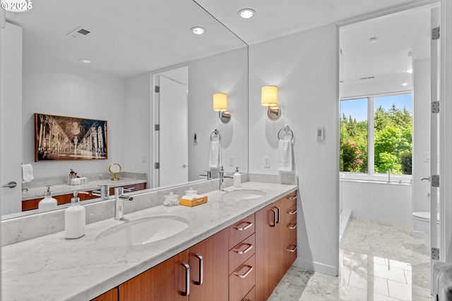 4140 NW Thunder Crest Rd, Portland, OR 97229 - bathroom featuring marble finish flooring, double vanity, toilet, baseboards, and recessed lighting
