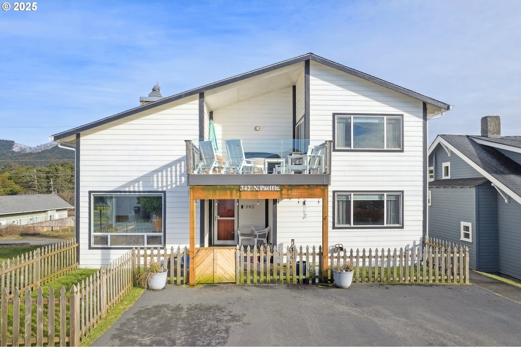 back of property with a balcony