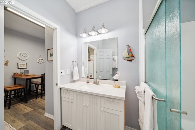 bathroom with hardwood / wood-style flooring and vanity