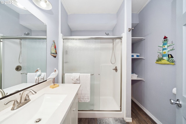 bathroom with an enclosed shower, hardwood / wood-style floors, and vanity