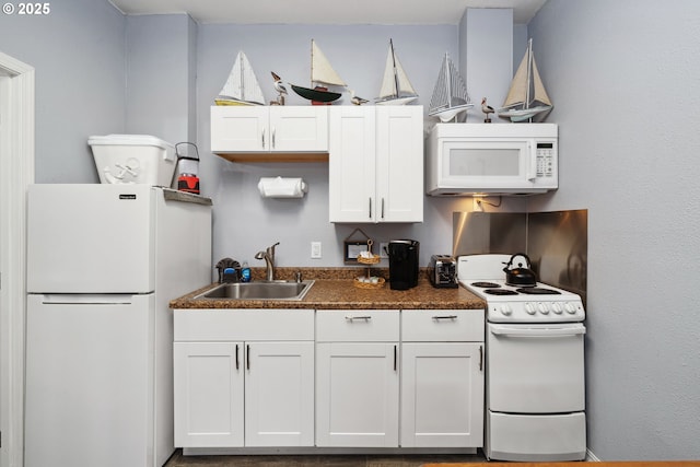 kitchen featuring white appliances, sink, and white cabinets