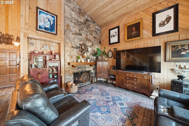 living room featuring high vaulted ceiling, a stone fireplace, wooden ceiling, and wood walls