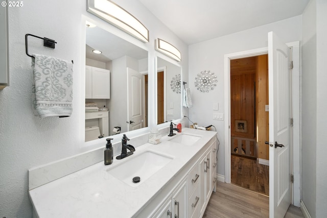 bathroom featuring hardwood / wood-style flooring, vanity, and toilet