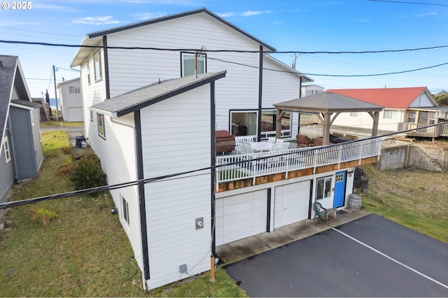 back of property with a gazebo and a lawn