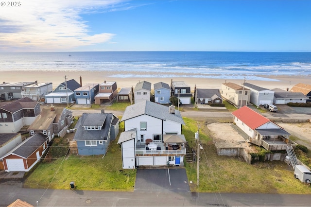 birds eye view of property with a view of the beach and a water view