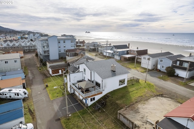 drone / aerial view with a water view and a view of the beach