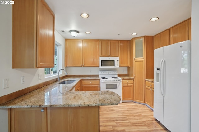 5264 NE 121st Ave Unit K67, Vancouver, WA 98682 - kitchen featuring white appliances, a sink, a peninsula, recessed lighting, and light stone counters