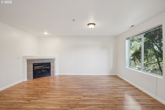 5264 NE 121st Ave Unit K67, Vancouver, WA 98682 - unfurnished living room with light wood finished floors, a tile fireplace, baseboards, and recessed lighting