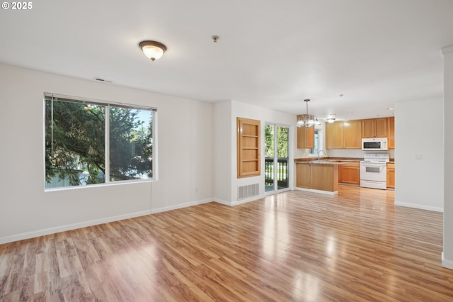 5264 NE 121st Ave Unit K67, Vancouver, WA 98682 - unfurnished living room with a chandelier, plenty of natural light, and light wood-style floors
