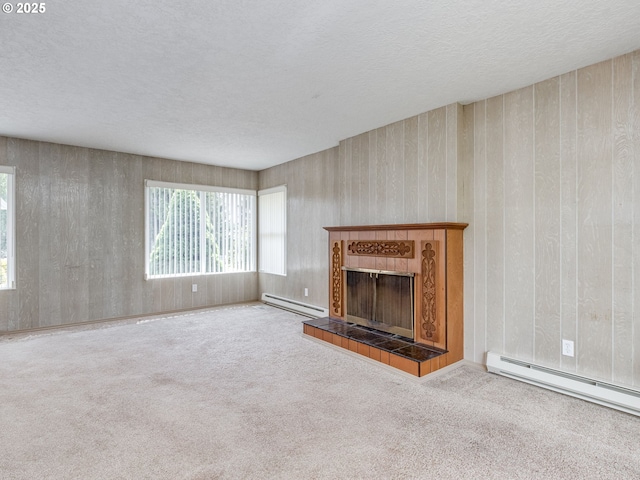 7804 NW 1st Ave, Vancouver, WA 98665 - unfurnished living room featuring baseboard heating, carpet, a tile fireplace, and a textured ceiling