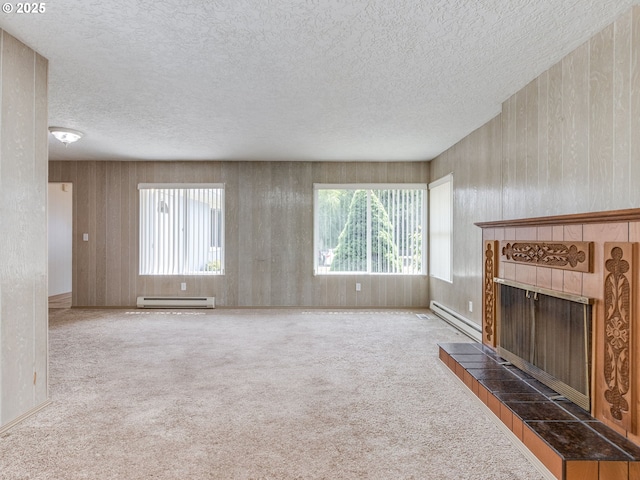 7804 NW 1st Ave, Vancouver, WA 98665 - unfurnished living room featuring a baseboard radiator, plenty of natural light, a tiled fireplace, and a textured ceiling