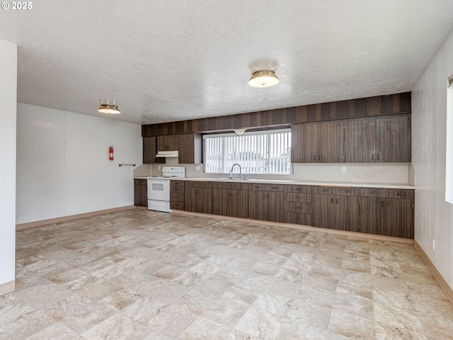 7804 NW 1st Ave, Vancouver, WA 98665 - kitchen featuring electric range, light countertops, under cabinet range hood, a textured ceiling, and dark brown cabinets