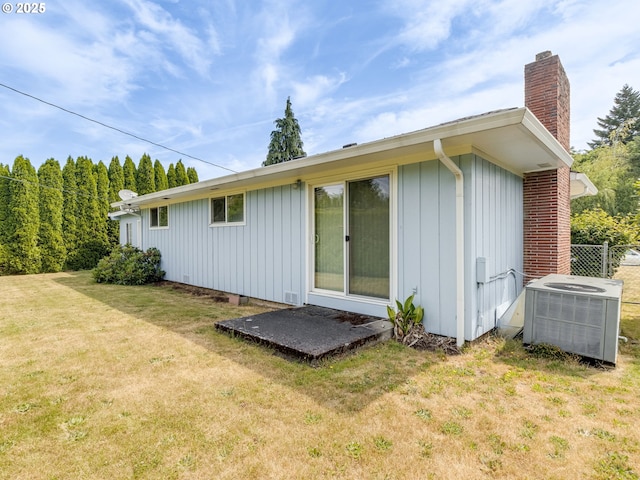 7804 NW 1st Ave, Vancouver, WA 98665 - rear view of property featuring a chimney, board and batten siding, and a lawn