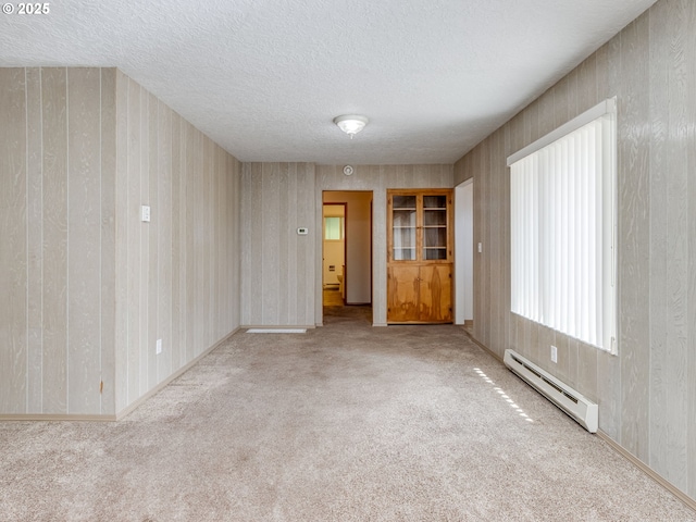 7804 NW 1st Ave, Vancouver, WA 98665 - carpeted empty room with a baseboard heating unit, a textured ceiling, and wallpapered walls