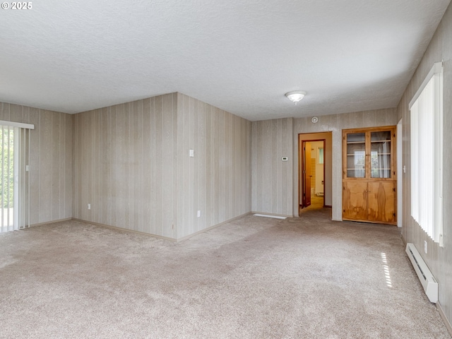 7804 NW 1st Ave, Vancouver, WA 98665 - spare room with a baseboard heating unit, healthy amount of natural light, carpet flooring, a textured ceiling, and wallpapered walls
