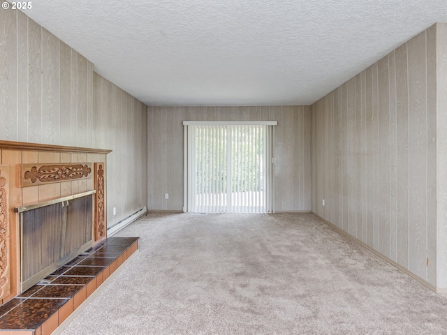 7804 NW 1st Ave, Vancouver, WA 98665 - unfurnished living room with baseboard heating, carpet floors, a textured ceiling, and a fireplace