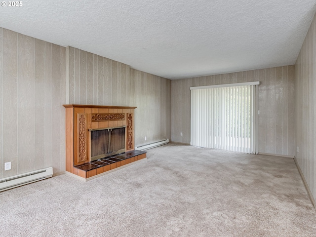 7804 NW 1st Ave, Vancouver, WA 98665 - unfurnished living room with a baseboard heating unit, a tiled fireplace, carpet flooring, and a textured ceiling