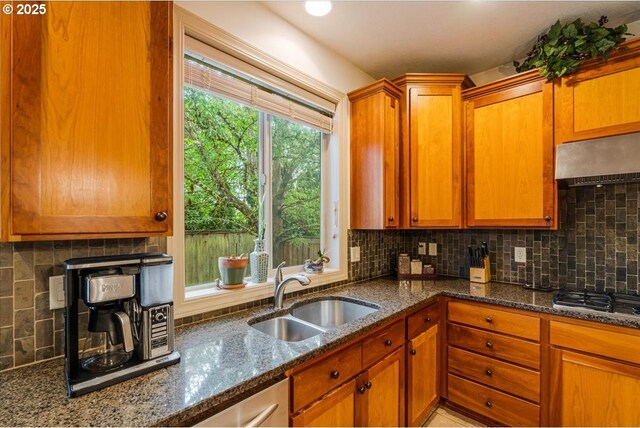 17544 SW Keystone Ct, Beaverton, OR 97007 - kitchen featuring a sink, stainless steel gas cooktop, ventilation hood, tasteful backsplash, and dark stone counters