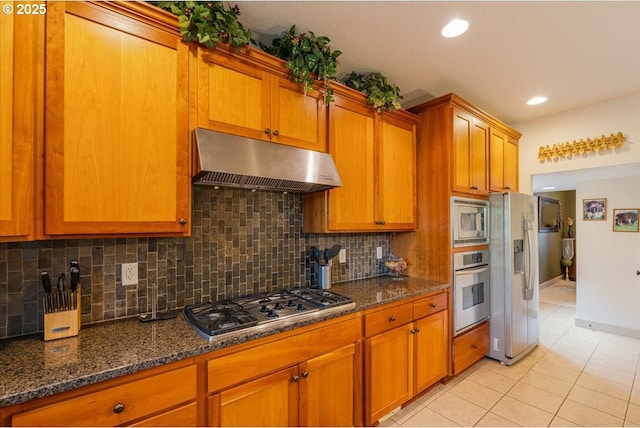 17544 SW Keystone Ct, Beaverton, OR 97007 - kitchen featuring under cabinet range hood, appliances with stainless steel finishes, light tile patterned floors, brown cabinetry, and recessed lighting