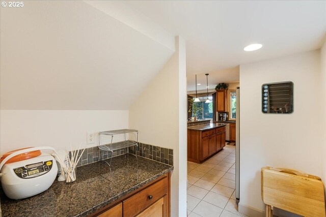 17544 SW Keystone Ct, Beaverton, OR 97007 - kitchen featuring brown cabinetry, light tile patterned floors, recessed lighting, and pendant lighting