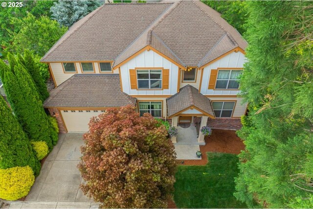 17544 SW Keystone Ct, Beaverton, OR 97007 - view of front of home with board and batten siding, driveway, a shingled roof, and a garage