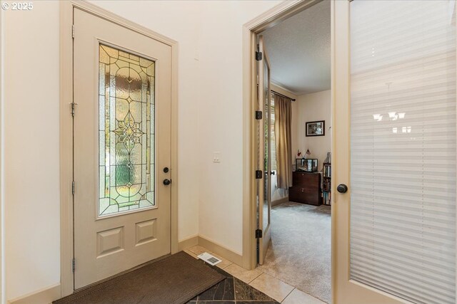17544 SW Keystone Ct, Beaverton, OR 97007 - entryway with light tile patterned flooring, plenty of natural light, baseboards, and light carpet