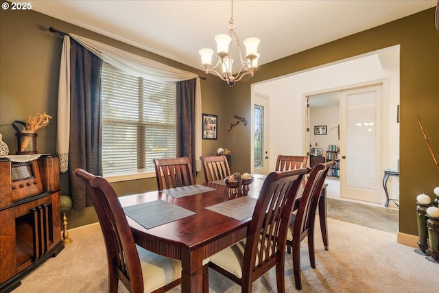 17544 SW Keystone Ct, Beaverton, OR 97007 - dining area with a chandelier, light carpet, and baseboards