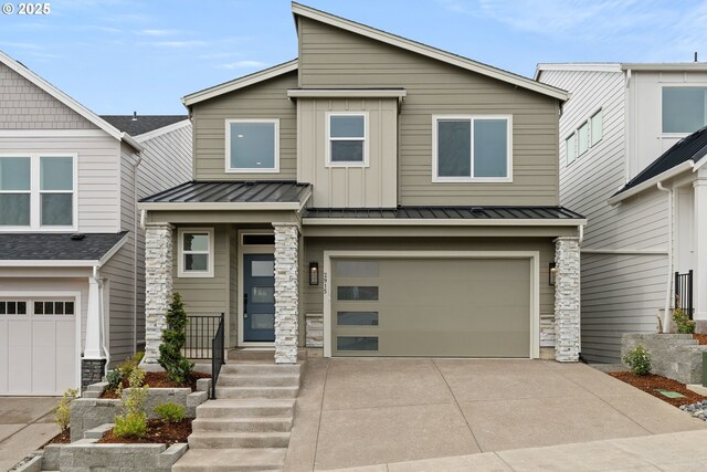 2901 NW 114th Ter, Portland, OR 97229 - view of front of home featuring stone siding, a garage, driveway, a standing seam roof, and board and batten siding