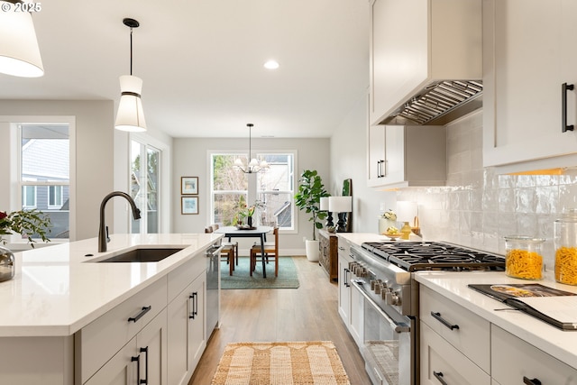 2901 NW 114th Ter, Portland, OR 97229 - kitchen with a sink, stainless steel range, light wood-style floors, wall chimney exhaust hood, and light countertops