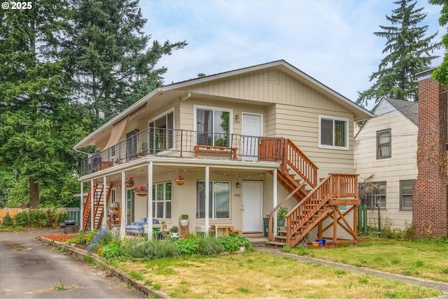 3400 E 13th St, Vancouver, WA 98661 - view of front facade featuring stairway, a front yard, a porch, and a balcony