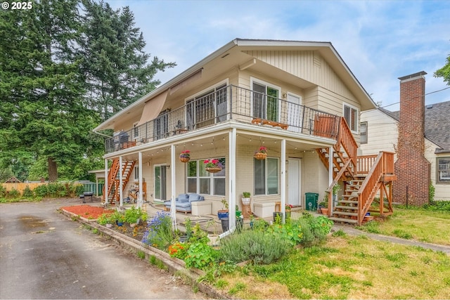 3400 E 13th St, Vancouver, WA 98661 - view of front of property featuring stairway, a balcony, brick siding, and a patio