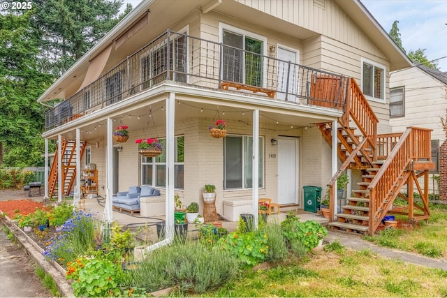3400 E 13th St, Vancouver, WA 98661 - view of front of home featuring stairway, brick siding, and a balcony