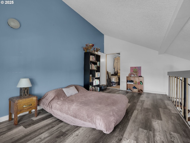 346 NE Skipanon Dr Unit 46, Warrenton, OR 97146 - bedroom featuring vaulted ceiling, wood finished floors, and a textured ceiling