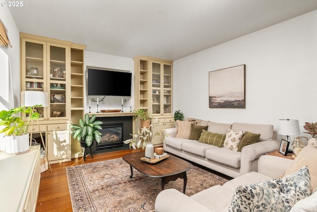 13765 SW Florentine Ave, Portland, OR 97223 - living room featuring wood finished floors and a fireplace with flush hearth