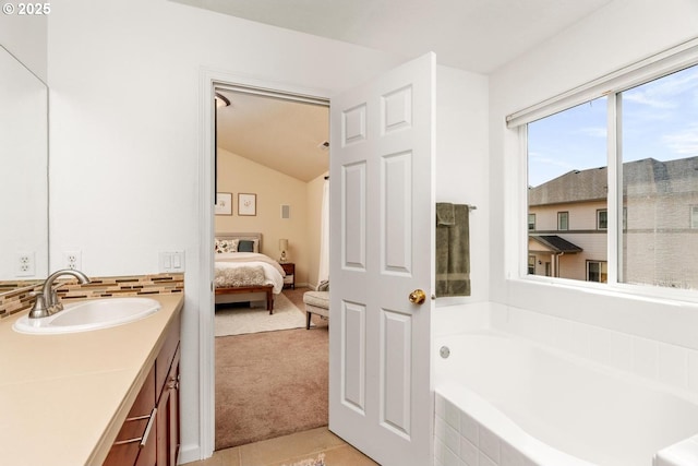 13765 SW Florentine Ave, Portland, OR 97223 - ensuite bathroom with vanity, a bath, vaulted ceiling, tile patterned floors, and backsplash