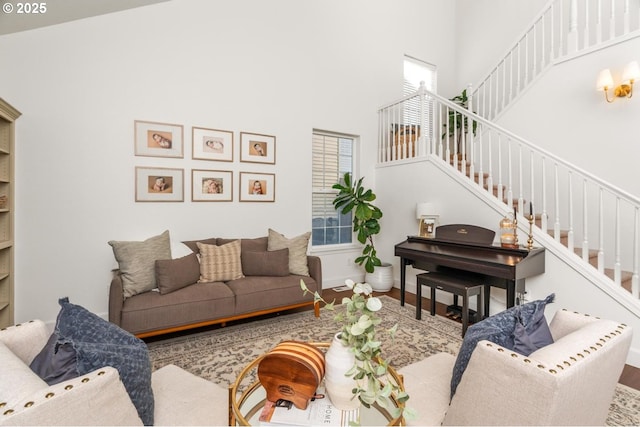 13765 SW Florentine Ave, Portland, OR 97223 - living room with a towering ceiling, stairway, wood finished floors, and baseboards