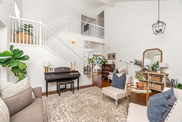 13765 SW Florentine Ave, Portland, OR 97223 - living area featuring stairway, a towering ceiling, wood finished floors, and a chandelier
