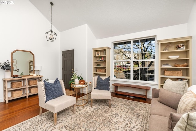 13765 SW Florentine Ave, Portland, OR 97223 - living area featuring wood finished floors, a chandelier, high vaulted ceiling, and baseboards
